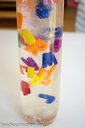 Alphabet sensory bottle after water and corn syrup has been added making streaks in the bottle