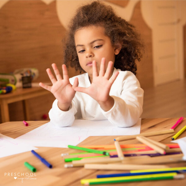 girl holding up all 10 fingers