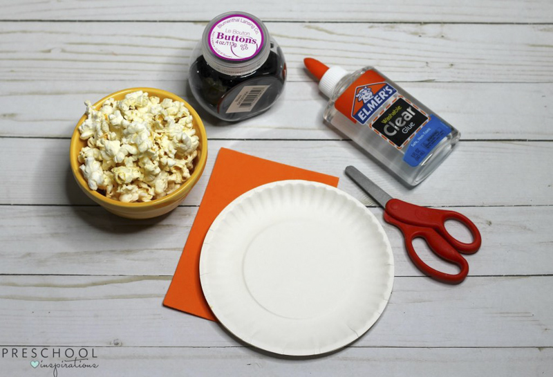 Materials to make popcorn paper plate snowman