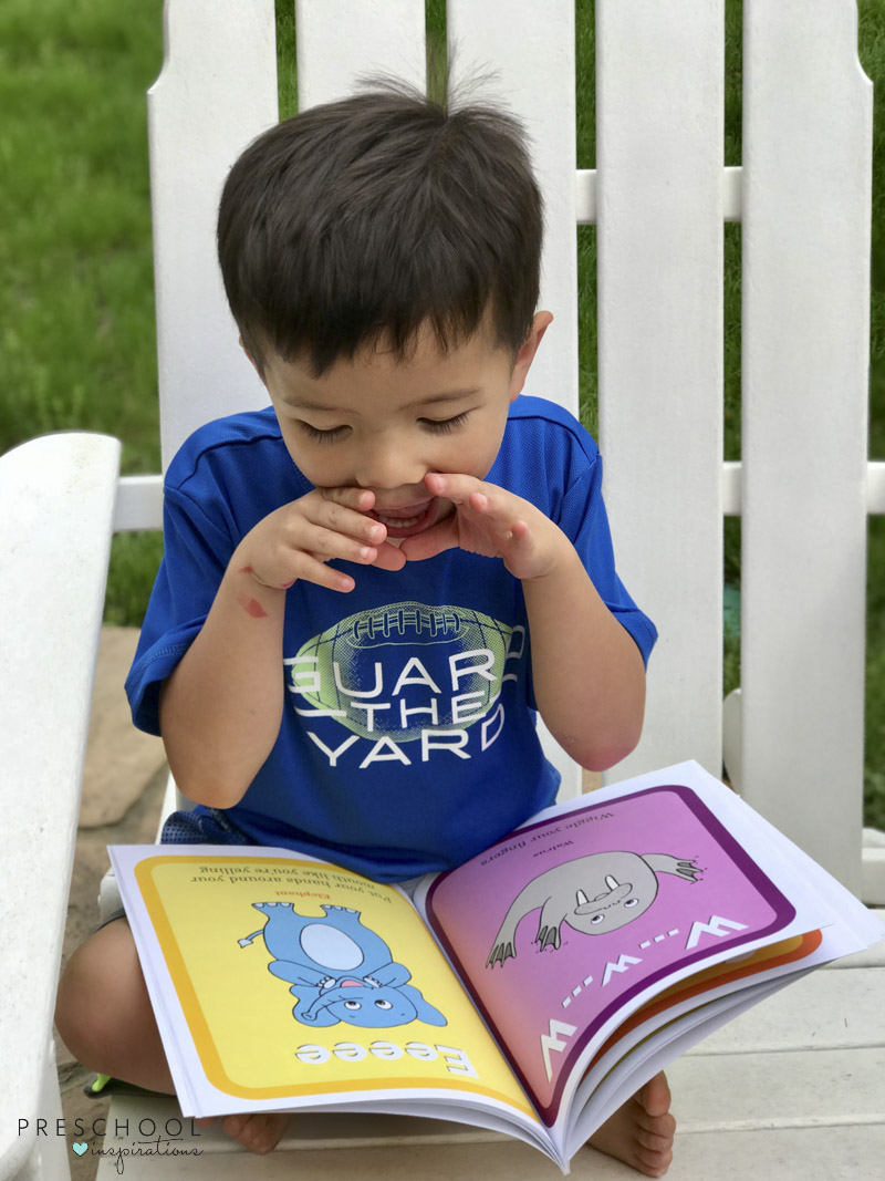 Boy using actions to learn to read with ABC See Hear Do