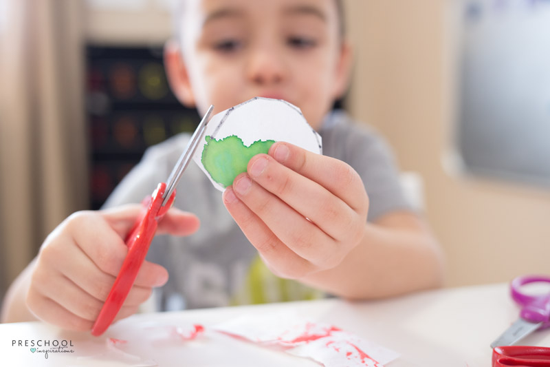 Set up a cutting tray for children to practice scissor skills with recycled art