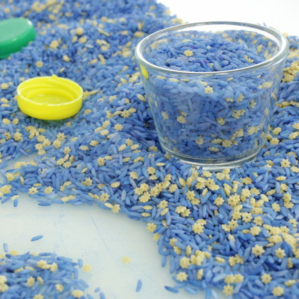 close up of dyed pasta in a night sky sensory bin